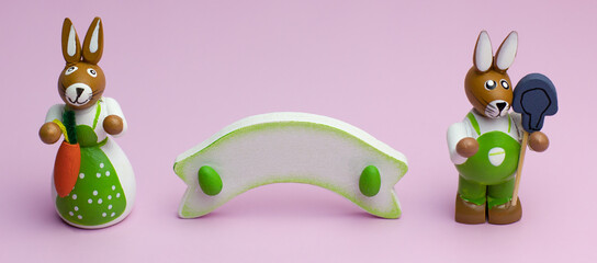 Two easter bunnies with copyspace on a pink background