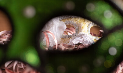 Carnival masks, beautiful venetian masks in detail with serpentine on a table, selective focus.