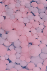 White, pink and blue soft pompons as a background.