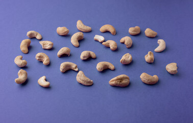 Cashew nuts on a blue background. Flat lay, top view.  