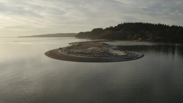 An aerial image of a sand bar jutting out from the shore in a frosty winter morning in the Pacific Northwest of Whidbey Island.