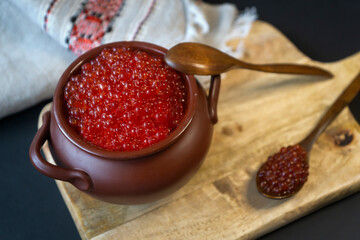 Still life. Maslenitsa week. A pack of Russian pancakes with red caviar in a rustic style, close-up.