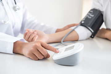 Doctor using a measuring blood pressure checking patient with examining, presenting results symptom and recommend treatment method, Healthcare and medical concept