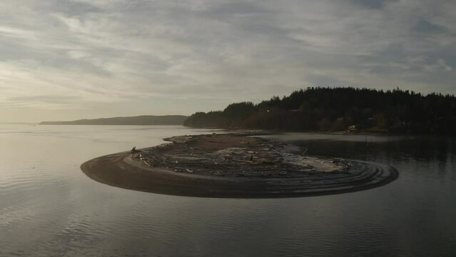 An aerial image of a sand bar jutting out from the shore in a frosty winter morning in the Pacific Northwest of Whidbey Island.