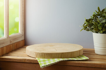 Empty wooden log board  on wooden table over window background. Spring and easter mock up for design.