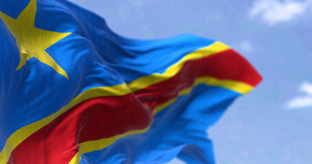 Detail of the national flag of the Democratic Republic of the Congo waving in the wind on a clear...