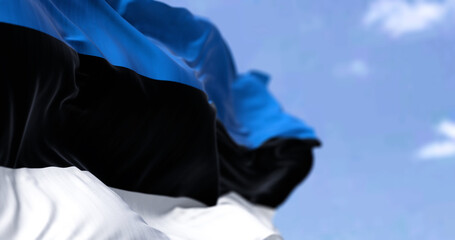 Detail of the national flag of Estonia waving in the wind on a clear day