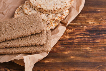 Wheat rye bread on food paper, on a wooden background.Healthy food for weight loss.