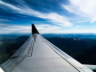 Airplane wing over the Glacier National Park in Montana