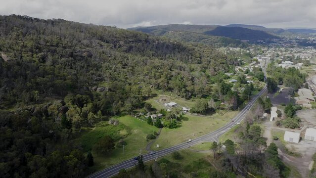 Drone aerial footage of houses and the Lithgow train maintenance facility in a large valley in The Central Tablelands of New South Wales in Australia