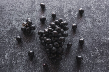 Fototapeta na wymiar bunch of black grapes on a dark background