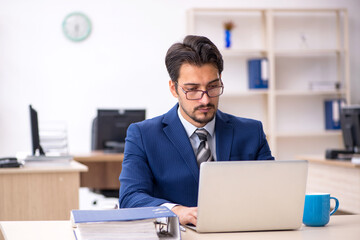 Young male employee working in the office