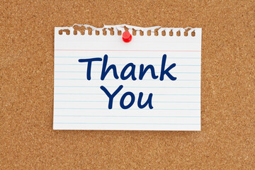 Thank you note message on paper on a bulletin board