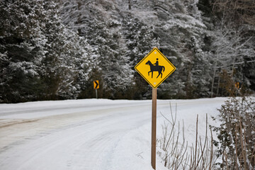 Yellow Caution Horse Riding Sign in a Rural Setting in Winter
