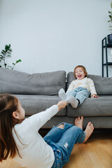 Strong girl pulling off sock of a boy, they are up for a tickling competition