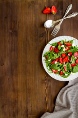 Fresh fruit salad with spinach and strawberry. Healthy happy meal