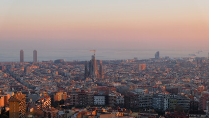 A view of barcenola city from Mirador de les bateries in sunset, with La Sagrada Familia church in the center.