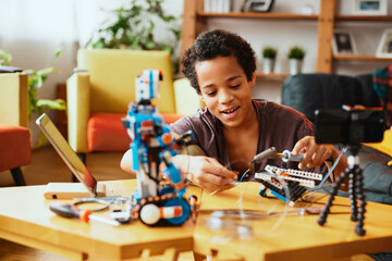 An educated little boy recording himself for a vlog and making a robot. Education in electronics and artificial intelligence.