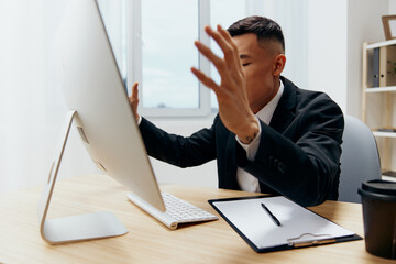 Fototapeta premium manager sitting at a desk in front of a computer emotions technologies