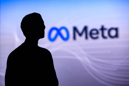 NEW YORK, USA, 1. MARCH 2022: Meta or Metaverse logo on big screen and Mark Zuckerberg silhouette. Facebook company, Meta Platforms