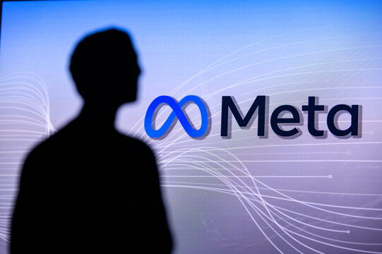 NEW YORK, USA, 1. MARCH 2022: Meta or Metaverse logo on big screen and Mark Zuckerberg silhouette. Facebook company, Meta Platforms