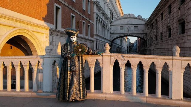 Venice, Italy - February 2022 - carnival masks are photographed with tourists in San Marco square