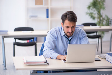 Young male employee working in the office