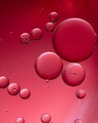 Composition of big and small colored circles oil drops on water.
