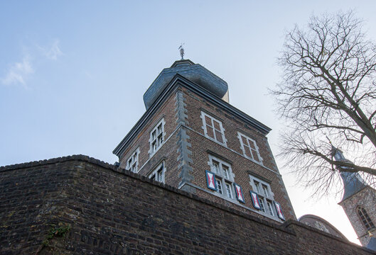 Vertical shot of Rolduc building tower against a blue sky in  Kerkrade, Netherlands