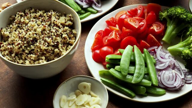 Vegan food ingredients for quinoa salad with tofu and fresh vegetables. Boiled quinoa grain, table spin.