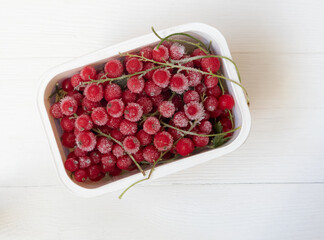 Frozen red and black currants in on a light background . The concept of preparing products for use in the future.