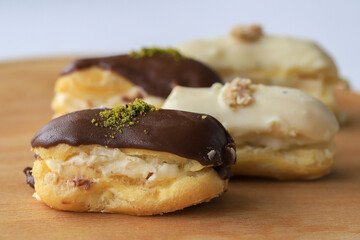 Traditional french eclairs filled with vanilla cream and powdered sugar. 