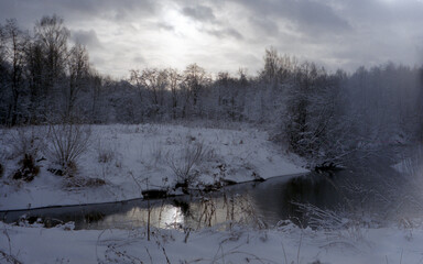 A winter river in the woods.