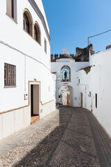 Matrera gate in a street of the old town of the white village of Arcos de la Frontera in Grazalema mountain range, Cadiz, Andalusia, Spain