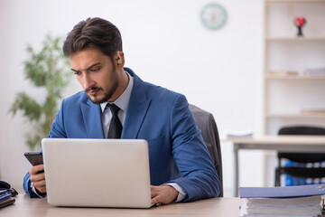 Deaf male employee using hearing aid at workplace