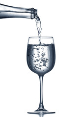 Pouring of clear water in glass isolated on white