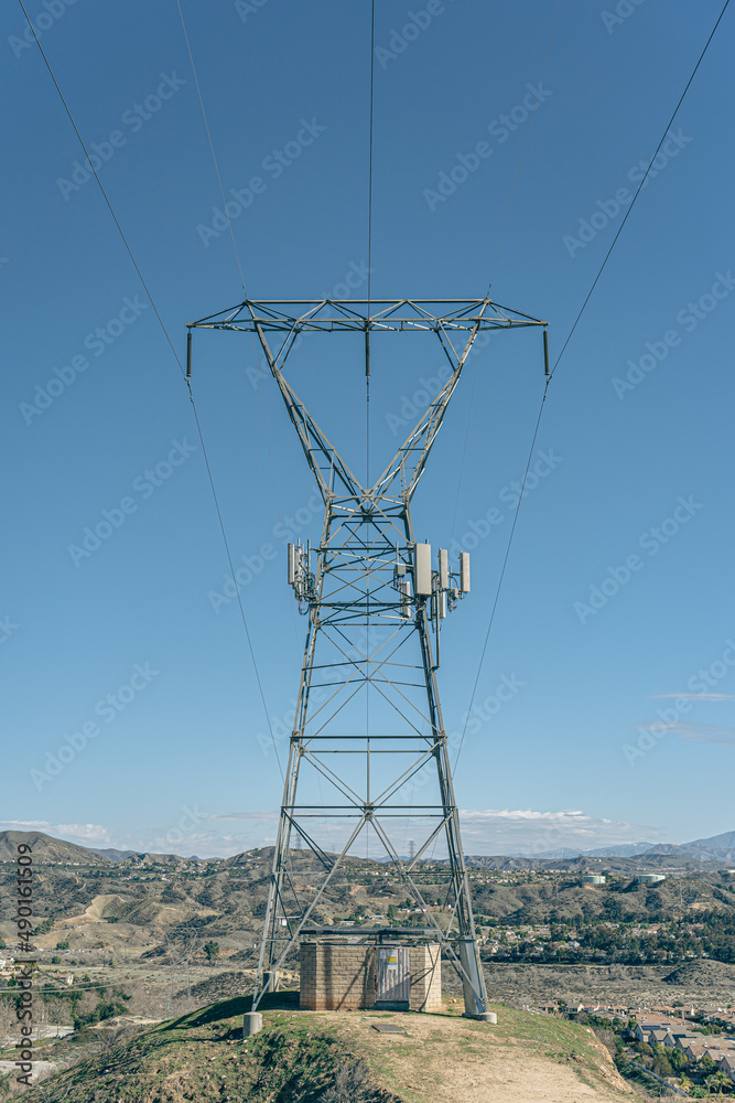 Wall mural Vertical shot of the high voltage transmission tower under the clear sky