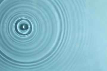 Closeup view of water with circles on turquoise background