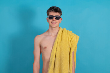 teen boy with sunglasses and beach or pool towel isolated on background