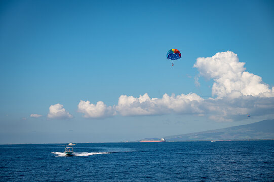 View of parasailing over the sea on a blue sky on a sunny day in Honolulu, Hawaii