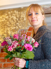 To brighten up any day. Portrait of a young woman holding a pretty bunch of flowers.