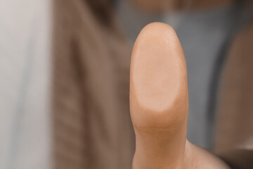 Woman pressing finger to surface, closeup view. Scanning fingerprint