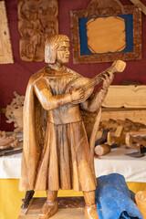wood carving depicting a minstrel playing his lute - obrazy, fototapety, plakaty