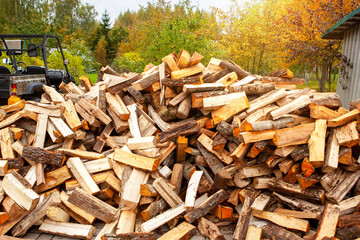 A pile of split firewood for heating the house.