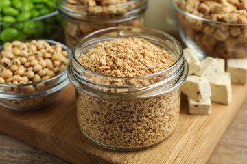 Dehydrated soy meat and other products on wooden table, closeup