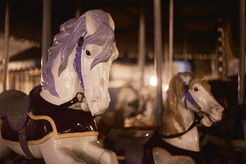 Photo of carousel horses at night