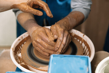 hands of a potter at work