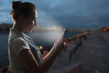 Beautiful Young Woman Using Smartphone Walking Through Night City Street background