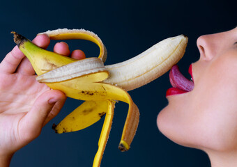 Theres something so a-peel-ing about bananas. Cropped studio shot of a young woman eating a banana...