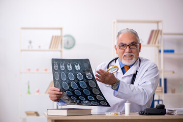 Old male doctor radiologist working in the clinic
